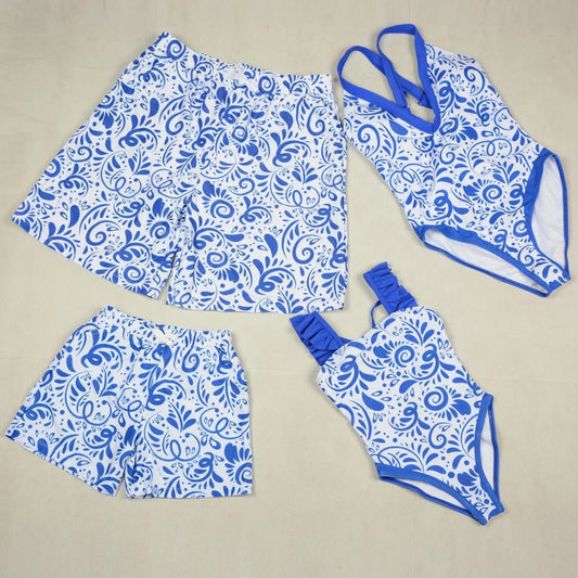 Blue and white patterned swimsuit set on a beige background