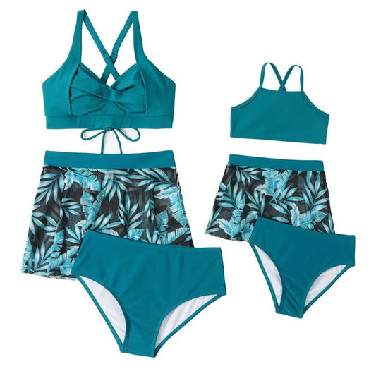 Teal bikini set with leaf patterned bottoms on a white background