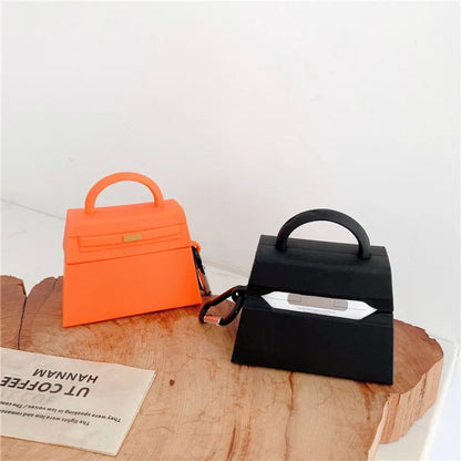 orange and a black handbag-shaped air pod case - ChildAngle Birkin AirPods Case