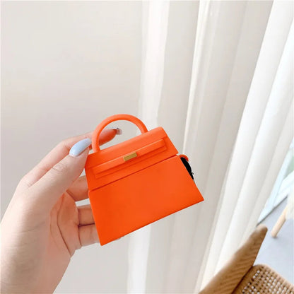 orange and a black handbag-shaped air pod case - ChildAngle Birkin AirPods Case