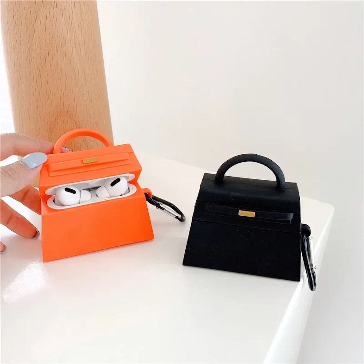 orange and a black handbag-shaped air pod case - ChildAngle Birkin AirPods Case