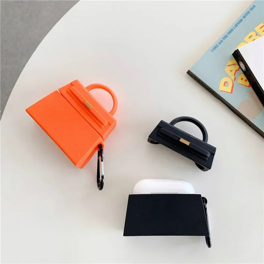 orange and a black handbag-shaped air pod case - ChildAngle Birkin AirPods Case