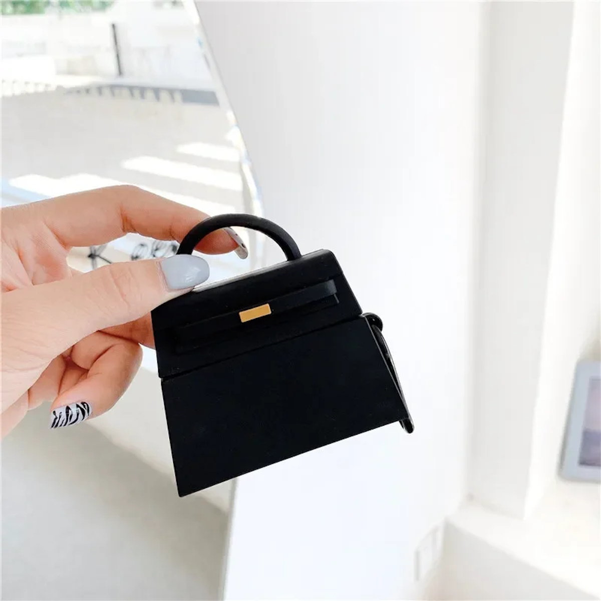 orange and a black handbag-shaped air pod case - ChildAngle Birkin AirPods Case