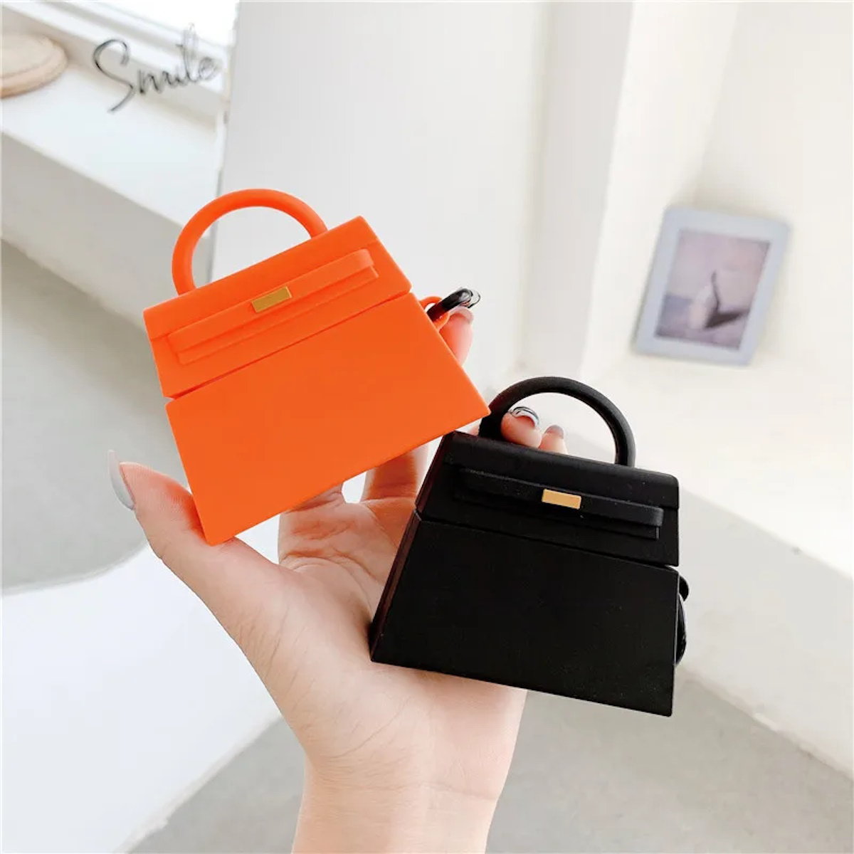 orange and a black handbag-shaped air pod case - ChildAngle Birkin AirPods Case