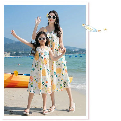 Two people in matching citrus-themed dresses standing  - ChildAngle Family Matching Outfits Set