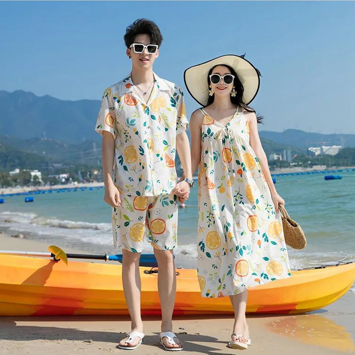 Couple in matching outfits with fruit patterns standing on a beach  - ChildAngle Family Matching Outfits Set