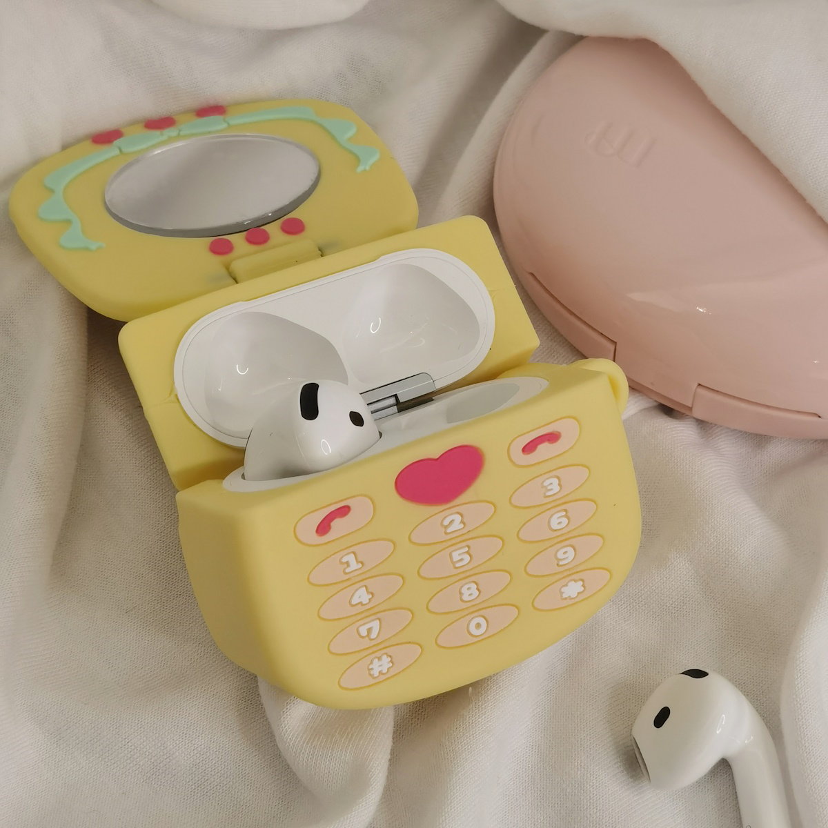 Yellow toy phone AirPods case - ChildAngle