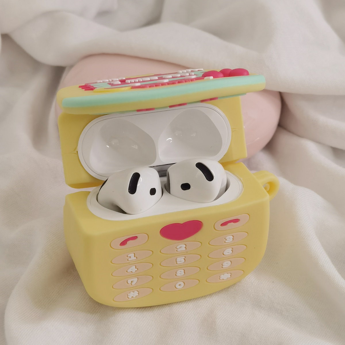 Yellow toy phone AirPods case - ChildAngle
