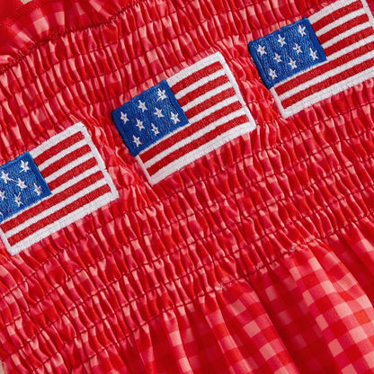 Child in a red checkered outfit with American flags - ChildAngle 4th of July Baby Romper