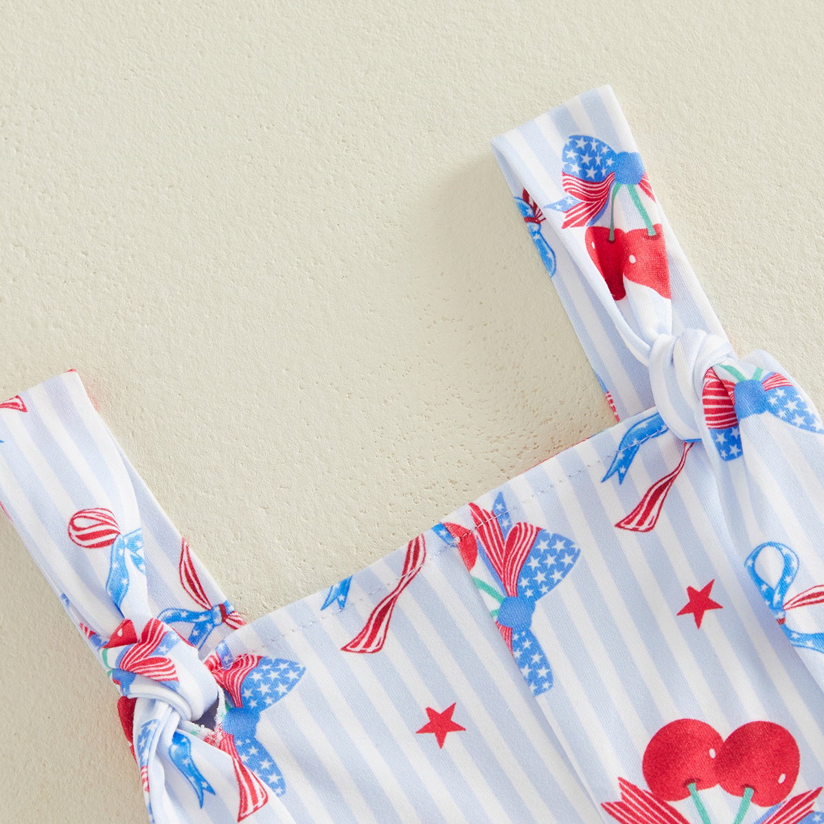 Child wearing a white outfit with red and blue floral patterns - ChildAngle Toddler 4th of July Outfits Shoulder Tie Jumpsuit
