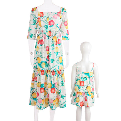 Two mannequins wearing matching floral dresses on a white background