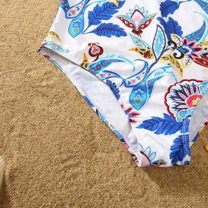 Colorful floral-patterned swimsuit bottom on sand