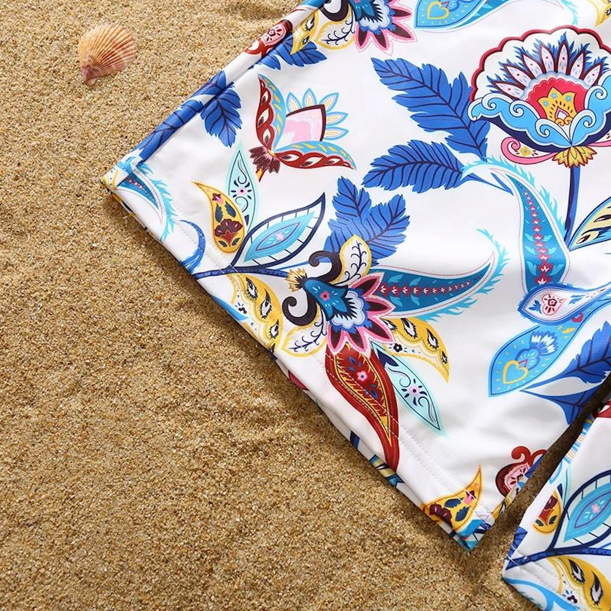 Colorful patterned fabric on a sandy surface