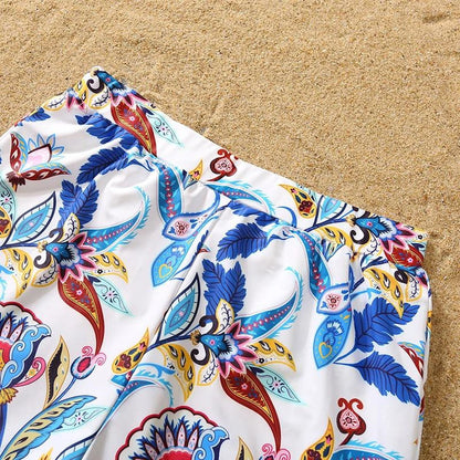 Colorful patterned fabric on a sandy background