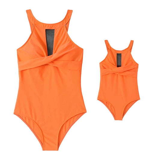 Two orange swimsuits, one larger and one smaller, on a white background.