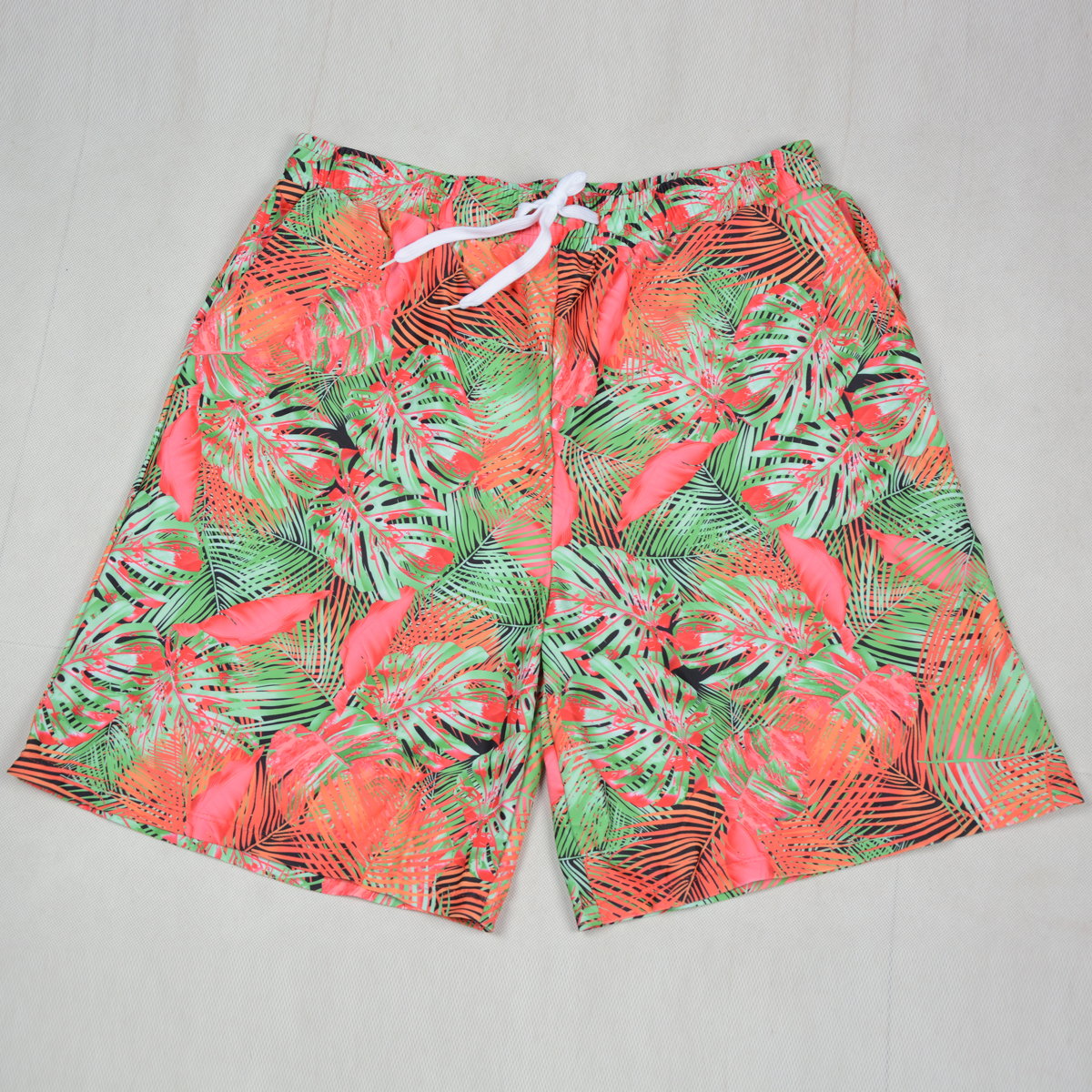 Tropical patterned shorts on a light gray background