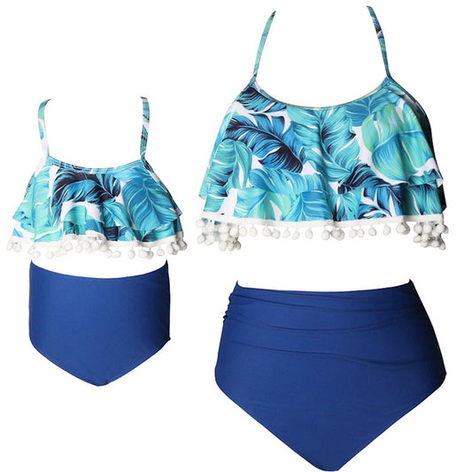 Two-piece swimsuit with tropical leaf pattern and blue high-waisted bottom  - ChildAngle