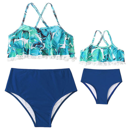 Two-piece swimsuit with tropical leaf pattern top and blue high-waisted bottoms - ChildAngle