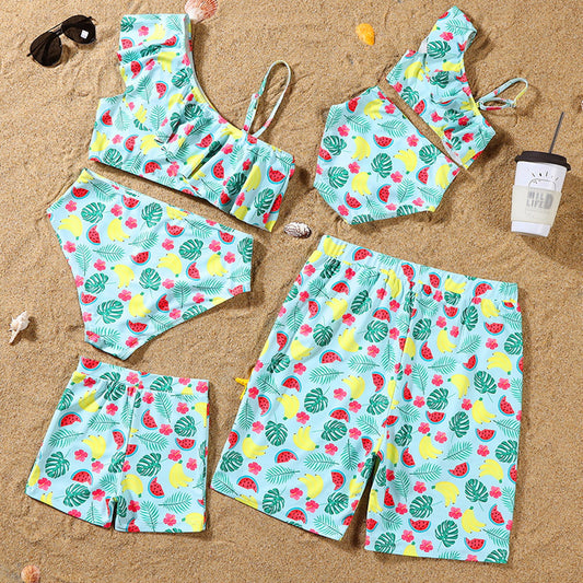 Set of swimwear with fruit pattern on sand