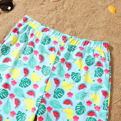 Colorful beach towel with tropical pattern on sand