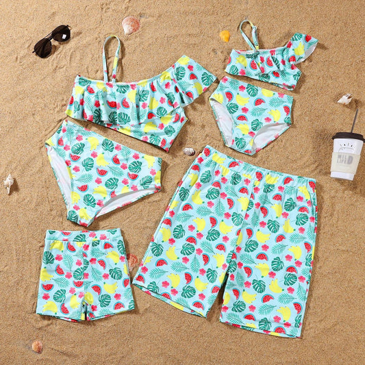 Colorful swimsuit set with tropical pattern on a sandy background