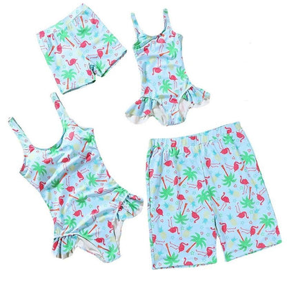 Children's swimwear set with flamingo and palm tree pattern on a white background