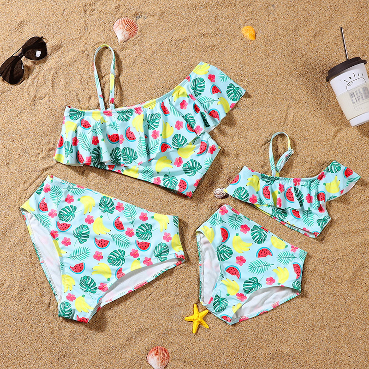 Children's swimsuit set with fruit pattern on a sandy background