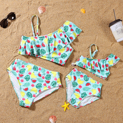 Children's swimsuit set with fruit pattern on a sandy background