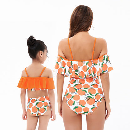 Two people wearing matching swimsuits with orange and white pattern - ChildAngle