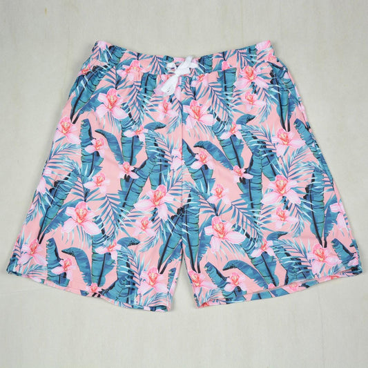 Tropical floral shorts on a light gray background