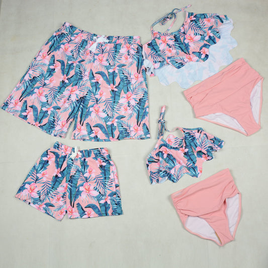 Floral and pink swimwear set on a light gray background