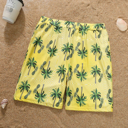 Yellow shorts with palm tree pattern on a sandy background