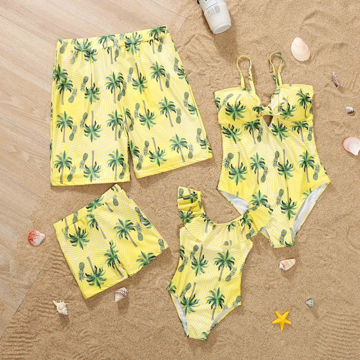 Yellow swimwear set with palm tree pattern on a sandy background