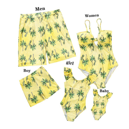 Yellow swimwear set with green palm tree pattern for men, women, girl, and baby on a white background.