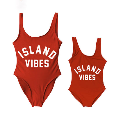 Two red swimsuits with 'ISLAND VIBES' text Mommy and Me One Piece Swimsuits - ChildAngle