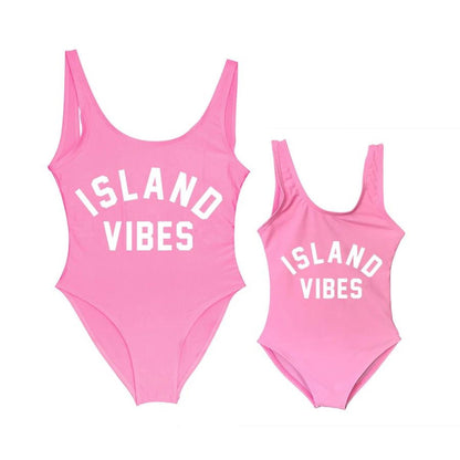 Two pink swimsuits with 'ISLAND VIBES' text Mommy and Me One Piece Swimsuits - ChildAngle