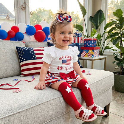 Child in patriotic outfit sitting on a couch with 4th of July decorations. - ChildAngle