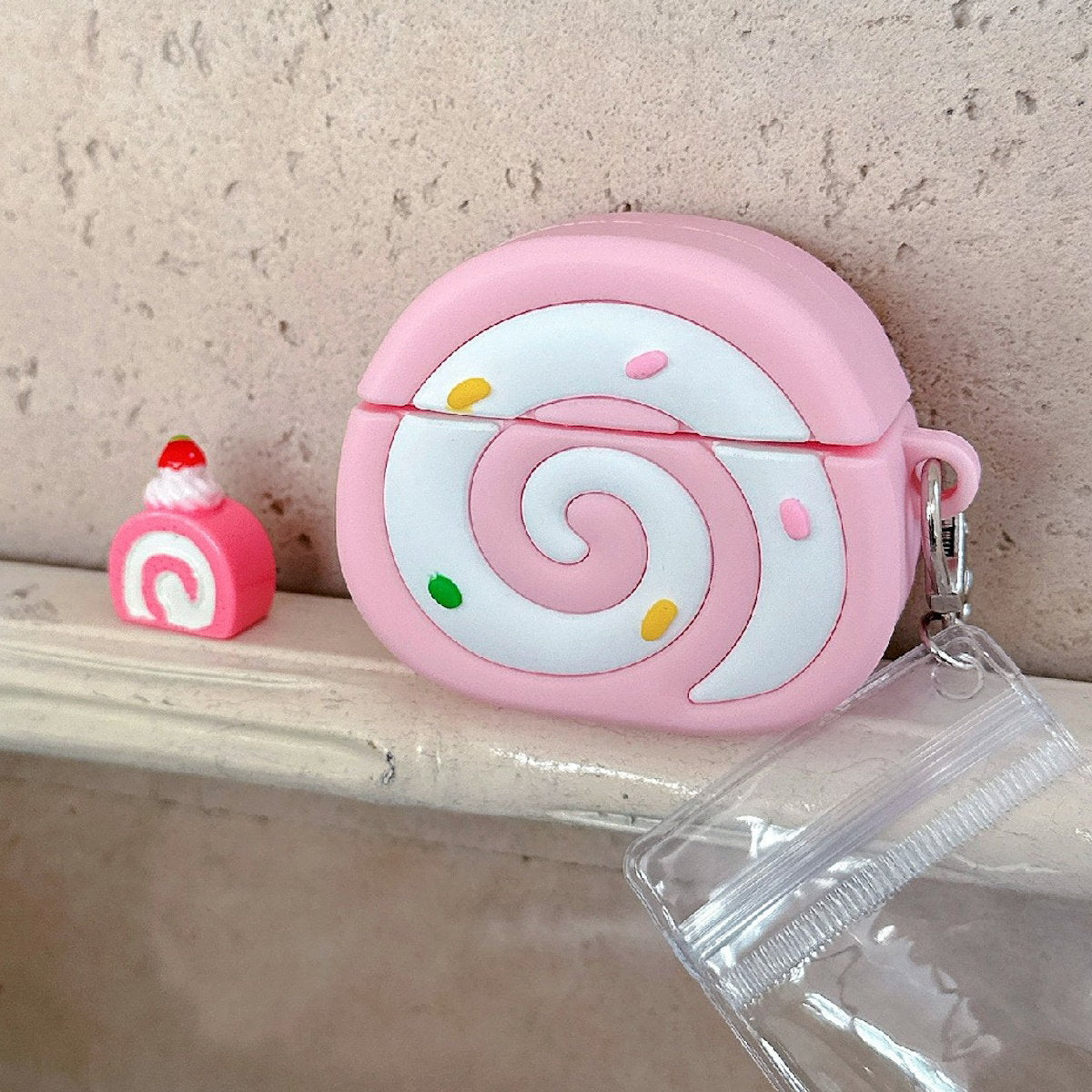 Pink Swiss Roll-shaped AirPods case - ChildAngle