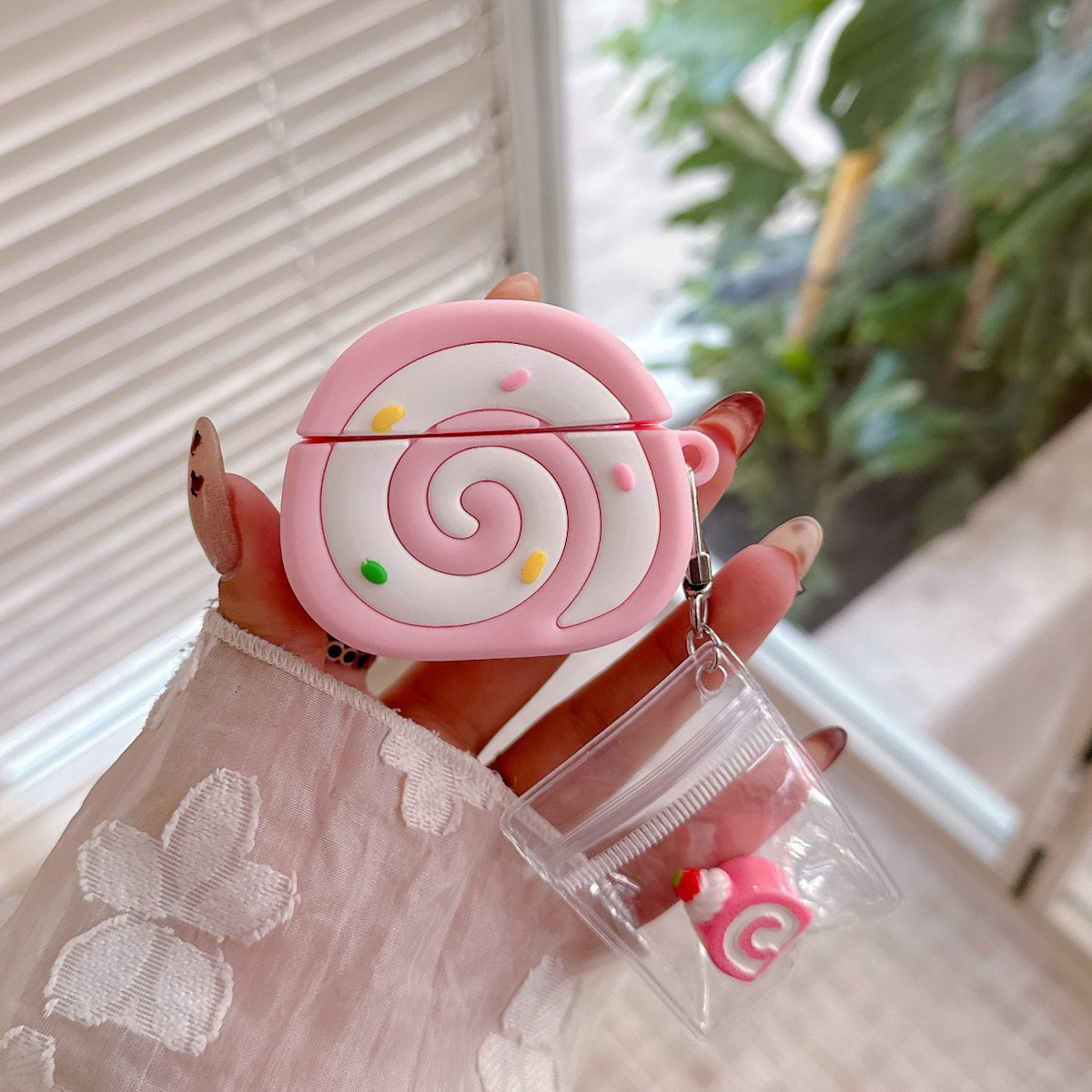 Pink Swiss Roll-shaped AirPods case - ChildAngle